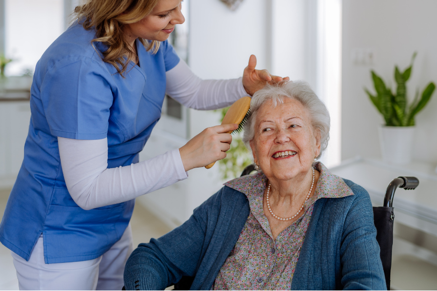 Enrogel staff providing grooming care to happy resident!